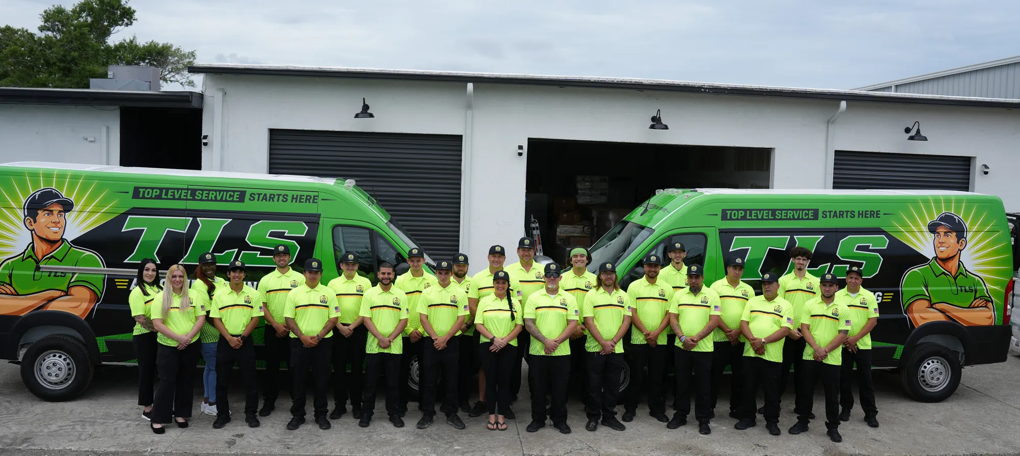 The TLS Air Conditioning team outside the Pinellas Park shop with the company vans